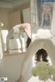 A woman doing a handstand in front of a mirror.