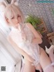 a woman in a white lingerie sitting on a bed
